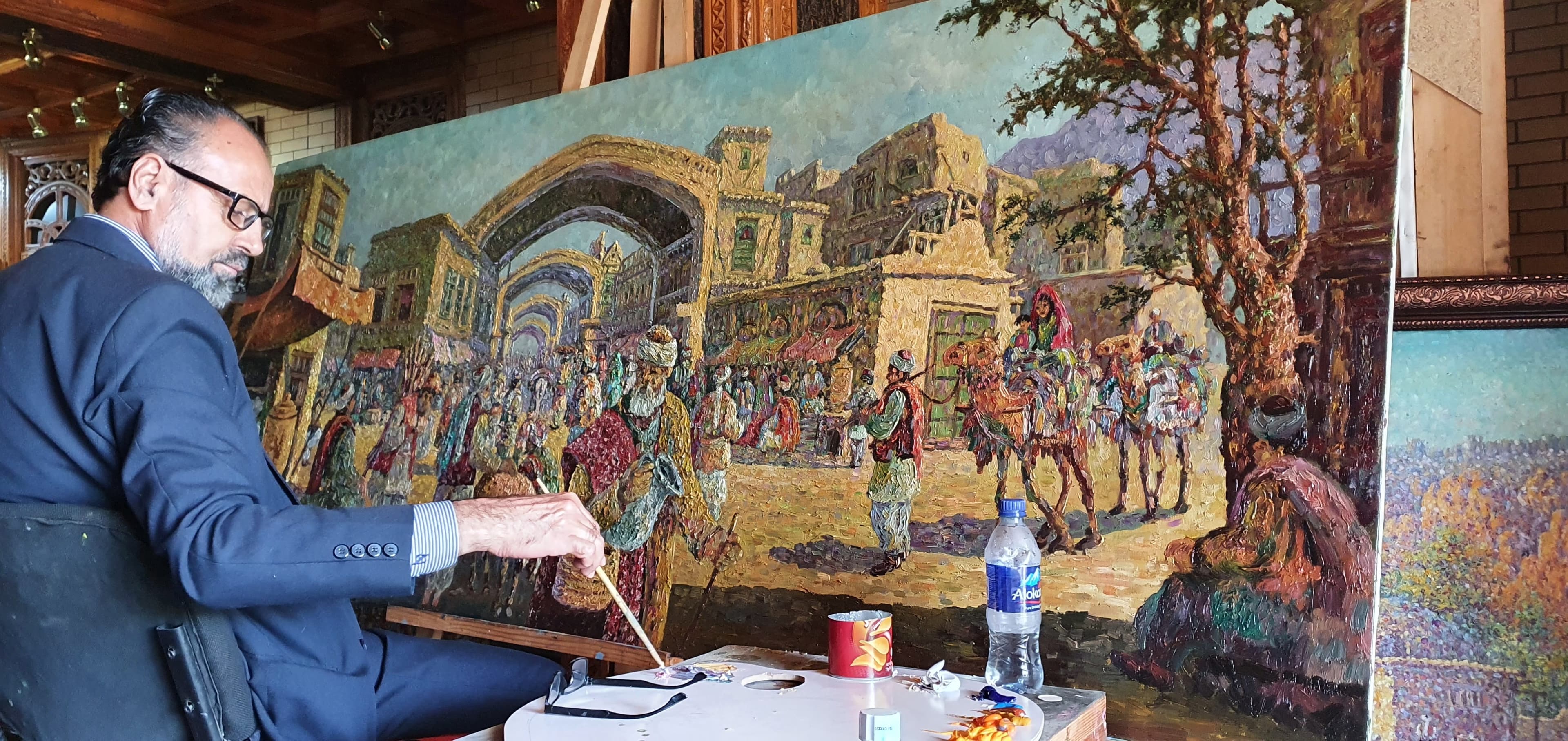 Dr. Asefi painting in his studio